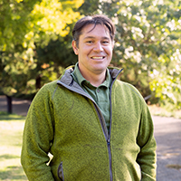Image of Tyler Kern, campus arborist, in the UC Davis Arboretum.