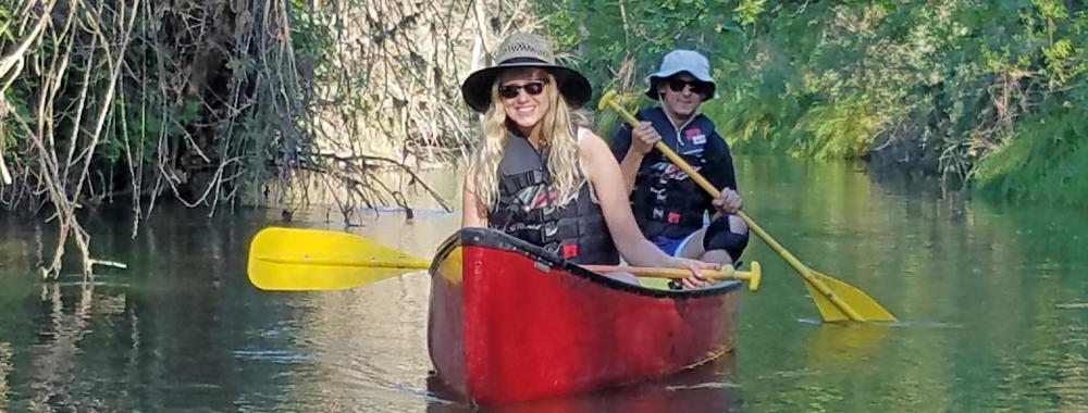 Image of students canoeing down Putah Creek in the Reserve.