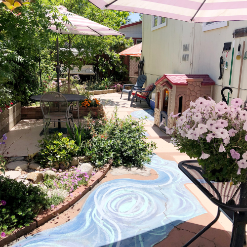 Tucker's yard after renovation with a painted path and flowers