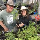 Image of Taylor Lewis and Abby Hart at the UC Davis Arboretum's Lath House where they propagate limited numbers of trees.